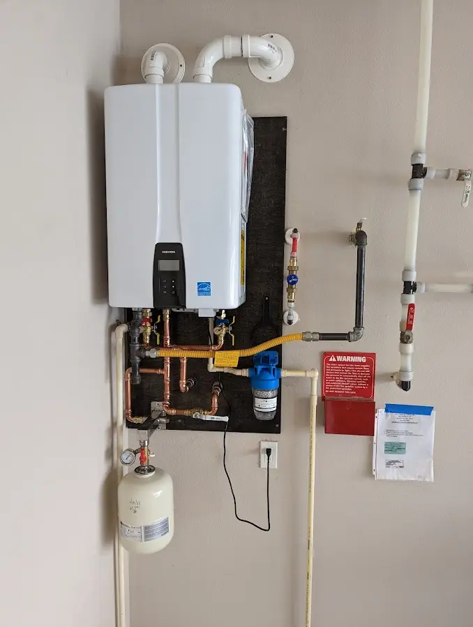 Professional plumber installing copper piping in a Flowery Branch home